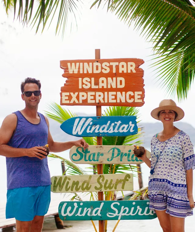 couples posing by sign