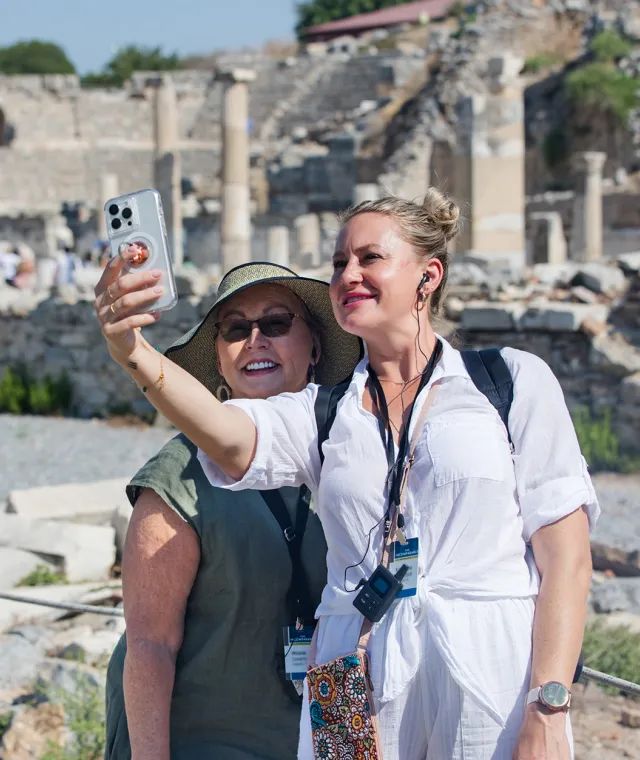 Two smiling travelers taking a selfie together