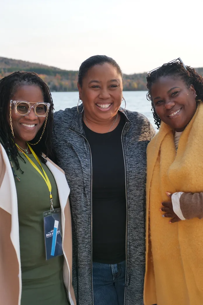 Chrystal Evans Hurst standing with two smiling women